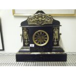 Monumental Mantle clock, black slate and marble the top section decorated with cherubs in a brass