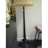 Good quality mahogany standard lamp with accompanying shade on tripod supports,