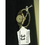 9ct gold Ladies 1950's wrist watch on an elasticated strap, appears to be working