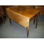 Late Georgian Pembroke table on turned supports with brass casters, single long drawer to the side,