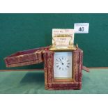 Miniature brass carriage clock in leather bound carrying case, clock measures 3" tall, small