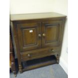 Ercol dark wood cupboard on stand, 2 doors above a single long drawer model credence