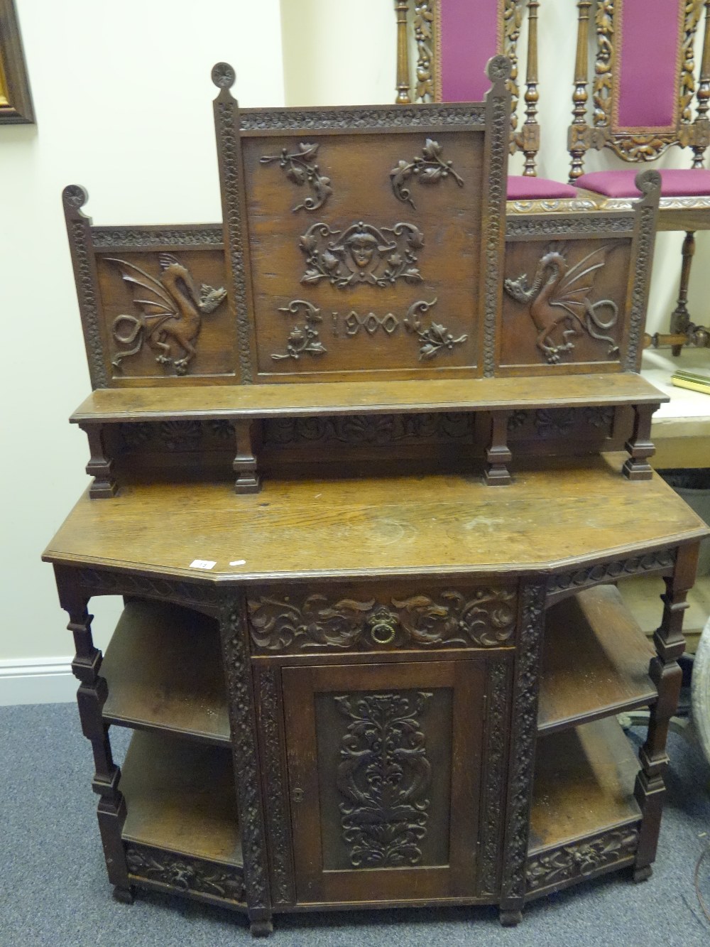 Delicate Arts & Crafts period profusely carved Chiffonier with a carved decorative back and 2 panels