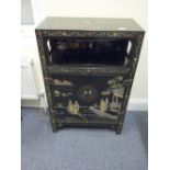 Early 20 th Chinosire black lacquered Oriental cabinet with 2 doors to the front, decorated with