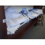 Shelf containing various lace and linen,