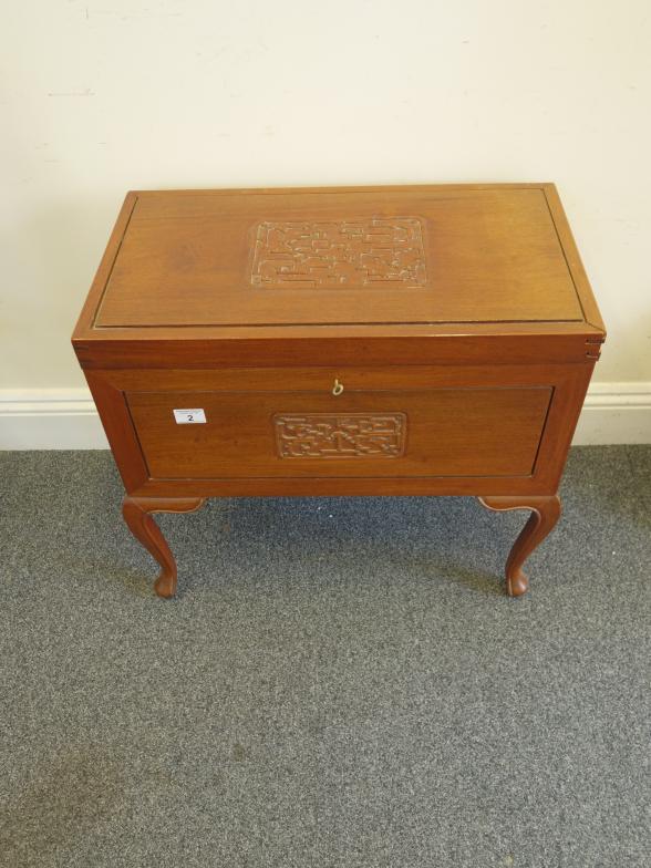 Oriental inspired metamorphic hardwood sewing box decorated to the top and front, the lid opening to