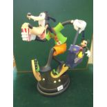 Walt Disney caricature Goofy holding a shopping bag model Goofy Tourist on a circular base, 24" tall