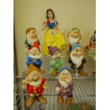 Collection of china figures, Snow White and the seven Dwarfs each marked to base Disney Japan, Dwarf