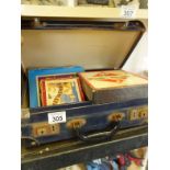 Old suitcase containing old children’s games including cribbage board, monopoly