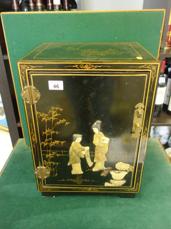 Black lacquered Japanese collectors cabinet decorated to the top and sides, front decorated with a