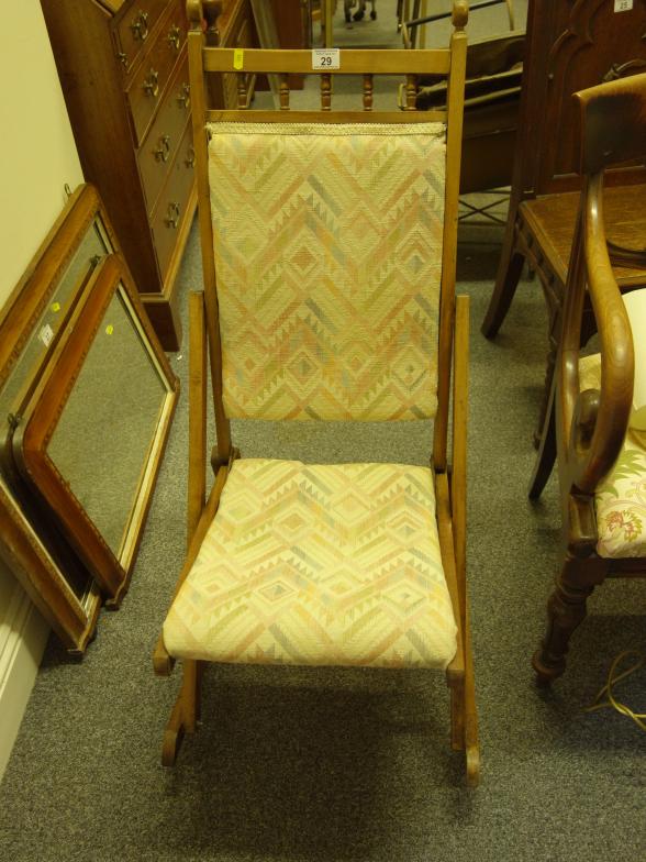 Delicate walnut metamorphic rocking chair with modern upholstery, probably used and a Ladies deck