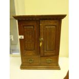 Oak Smokers cabinet of small proportions, 2 cupboards to the front revealing a flight of drawers,