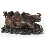 A 20th C. hardwood carving Water buffalo ridden by three figures (later adapted as a lamp base) On