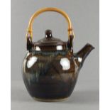 A Winchcombe Pottery stoneware Teapot of globular form with combed brown / green decoration & cane