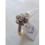 A seven stone diamond and flower head ring set in 18ct gold and platinum