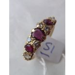 A nine stone ruby and diamond ring set in gold