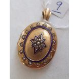 An attractive Victorian 15ct gold enamel and pearl oval locket the hinged body revealing a photo