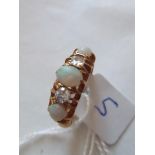 A five stone opal and diamond half hoop ring set in 18ct gold