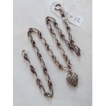 A fancy silver knot neck chain with heart shaped locket