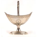 George III Irish silver sugar basket Of navette shape with fluted corners, the swing handle,