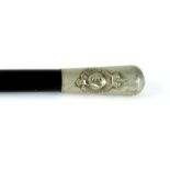 A Royal Irish Constabulary swagger stick. An early 20th century white metal topped, ebonised,