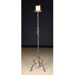 A Wrought Iron Floor Standing Pricket Ca