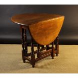 A Small Walnut Gateleg Table.  The oval