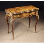A Marquetry Flip-top Games Table with gilt metal mounts, inlaid all over with panels of flowers,