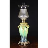 A Tall Art Nouveau Style Oil Lamp having a moulded baluster body dripped in ochre,