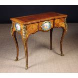 A Louis XV Style Porcelain-mounted Writing Table quarter-veneered in tulipwood with inlaid