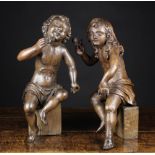 A Good Pair of Late 17th/Early 18th Century Carved Oak Curly-haired Putti holding sprigs of flowers