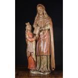 A 16th Century Oak Carving of 'The Teaching of Mary' with traces of polychrome.