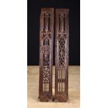 A Pair of 15th Century Pierced Oak Slats carved with Gothic Tracery incorporating an heraldic