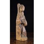 A Rare 14th Century Carved Oak Figural Corner Post in the form of a Monk seated on a Choir Stall,