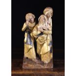 A 16th Century Polychromed Relief Carved Retable Fragment depicting three lamenting figures,