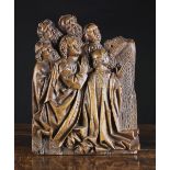 A 15th Century Retable Fragment Carving of Apostles, 15 ins x 11½ ins (38 cm x 29 cms).