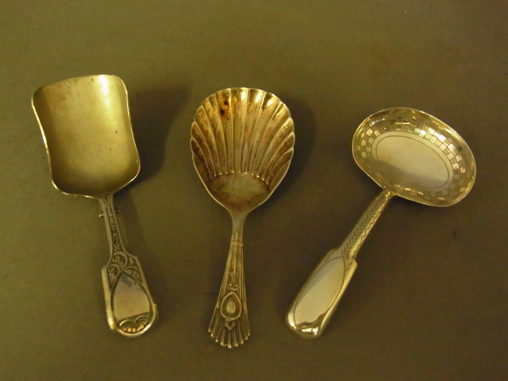 A collection of three silver caddy spoon