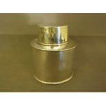 A cylindrical silver tea caddy bearing