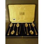 A boxed set of silver teaspoons and nip