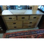 An oak seven drawer wide chest W 140cm x