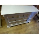 A painted white chest with slight scratc