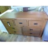 An oak seven drawer wide chest W 140cm x