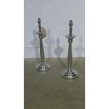 A pair of plated table lamps on round ba