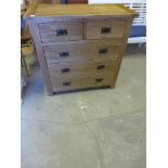 An oak two over three chest of drawers -