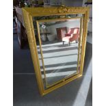 A gilt framed mirror with bevelled edge