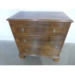 A re-veneered walnut three drawer chest