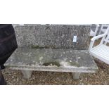 A two seater concrete garden bench in fo