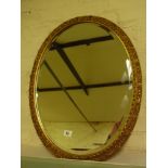 A modern oval gilt mirror - 68 cm x 52 c