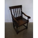 A Wainscoat style oak carved chair - Wid
