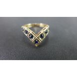 A 9ct gold sapphire chevron-shape ring -